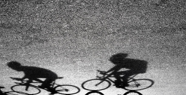 istock Blurry silhouette and shadow of  professional cyclists 947932058