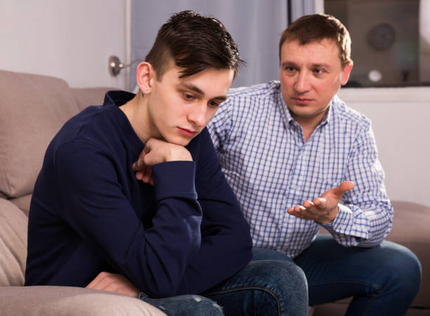 istock Adult man is asking forgiveness from his sad son after conflict 947935430
