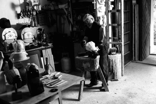 istock Senior man working on marble sculpture in his workshop. 947951282