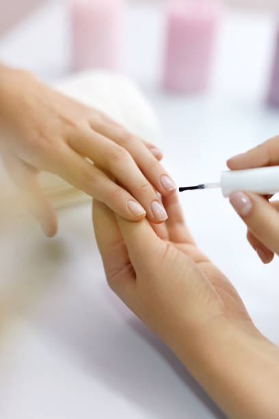 istock Nail Care. Beautiful Female Hands Applying Polish On Nails 947951388