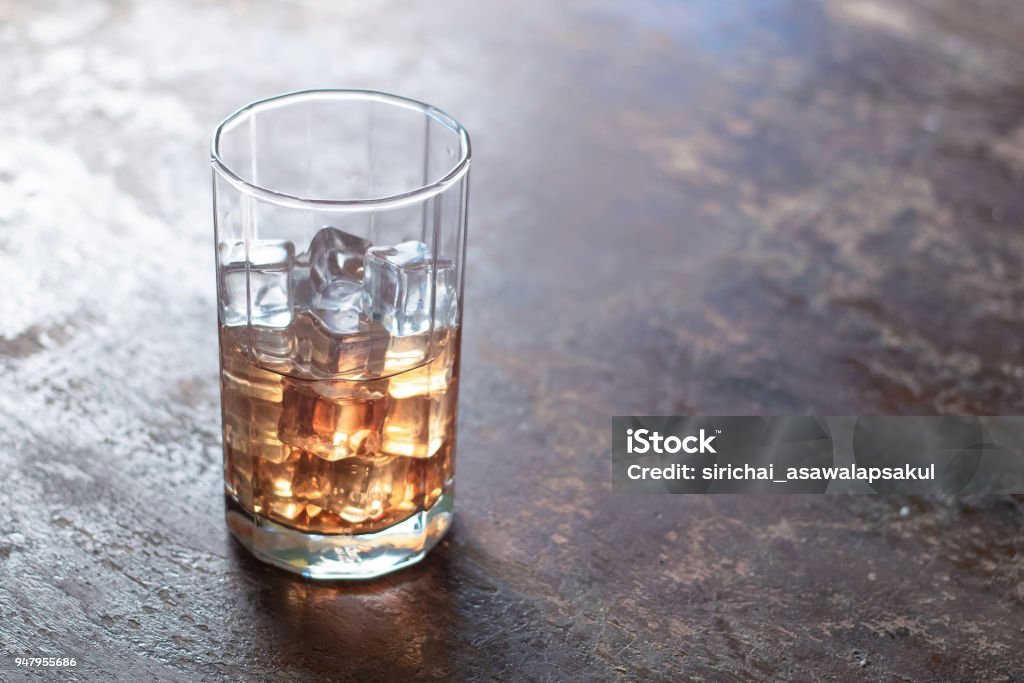 Glass of whiskey with ice on black background Alcohol - Drink Stock Photo