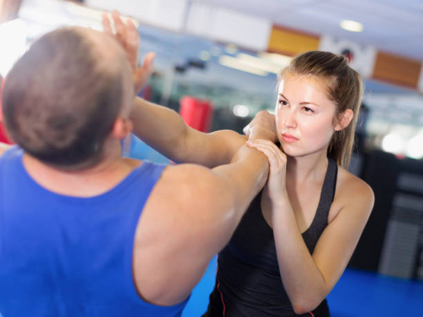 istock Girl and trainer are training kicks on the self-defense course 947956708
