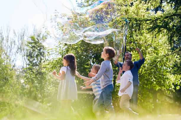 soap bubble show at full speed - bubble child bubble wand blowing imagens e fotografias de stock