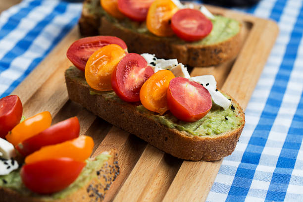 istock close up avocado sauce on bread with cheese, tomatoes and black sesame 947959338