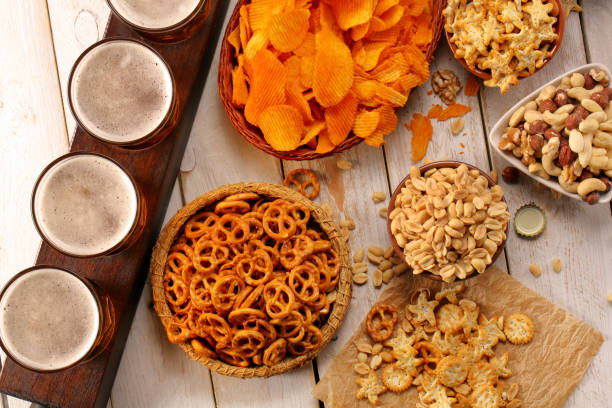 Lager beer and snacks on wooden table