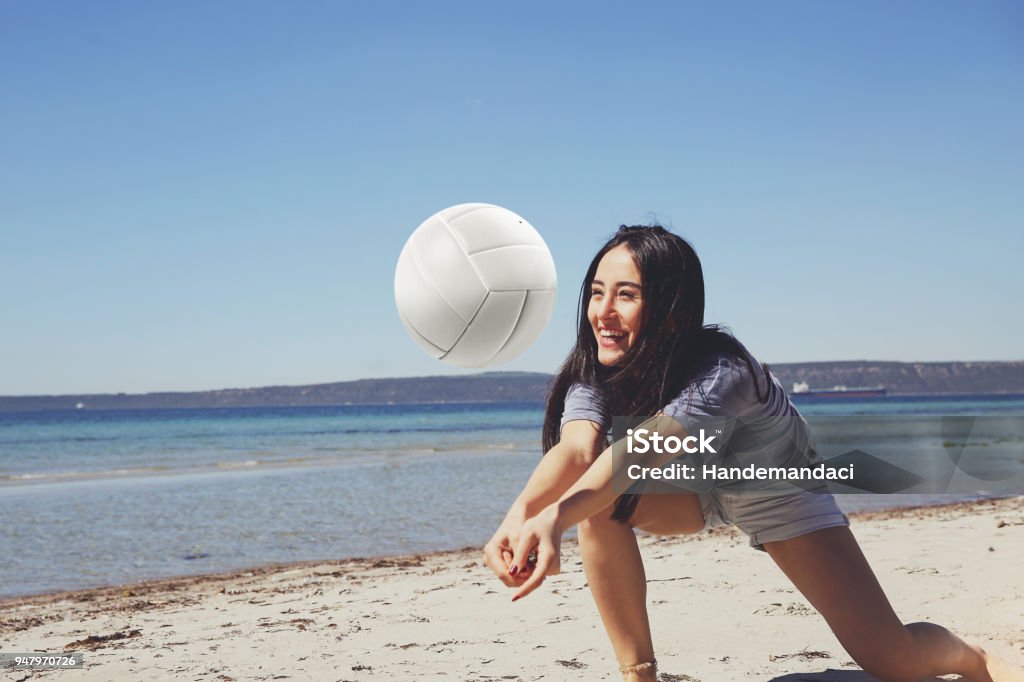 One young beautiful lady is playing volleyball on the beach Volleyball - Sport, Beach Volleyball, Women, Sport, Females, Summer, Enjoy Beach Stock Photo