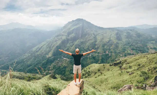 Traveler man enjoy mountains landscape. Travel concept vacations hiking in mountains on Little Adam's Peak, Sri Lanka