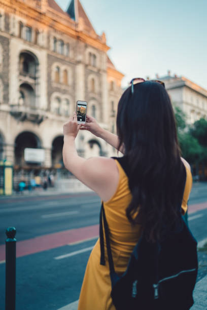 istock Tourist in Budapest taking photos with smartphone 947988192