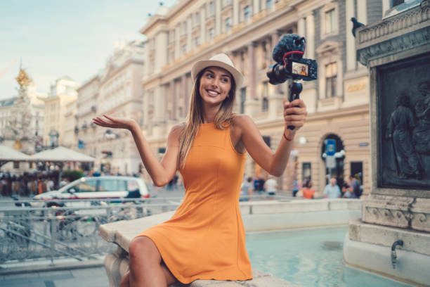 Attractive woman vlogging from Vienna Young woman on a summer vacation vlogging from the city sound recording equipment photos stock pictures, royalty-free photos & images