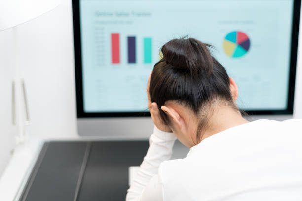 istock Feeling tired and stressed. young woman suffer from working while sitting at her working place in office 947994678