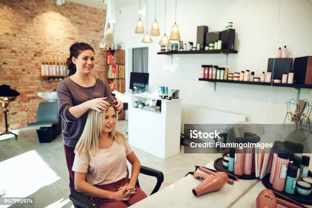 Young Woman Talking With Her Hairstylist During A Salon Appointment Stock Photo - Download Image Now