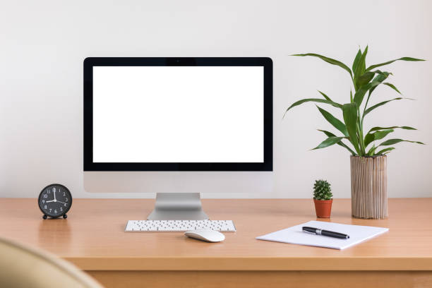istock All in one computer, mouse, keyboard, paper, pen, cactus and tree vase  on wooden table 948005774