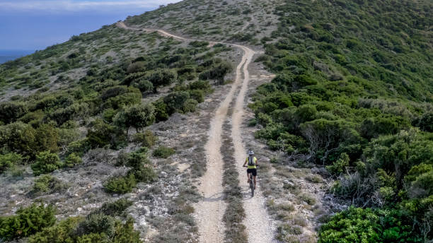 istock Woman cycling along ridge on trail 948009706