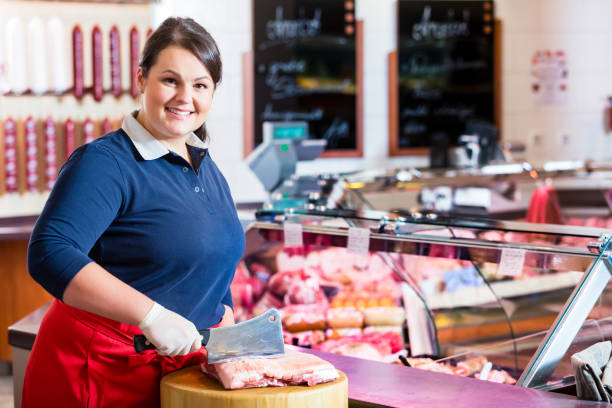 istock Butcher woman chopping meat on a block 948020166