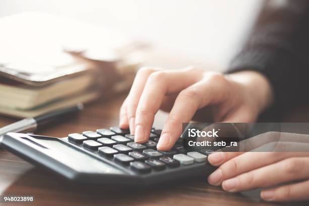 Hand Using Calculator On The Table Stock Photo - Download Image Now - Calculator, Table, Business