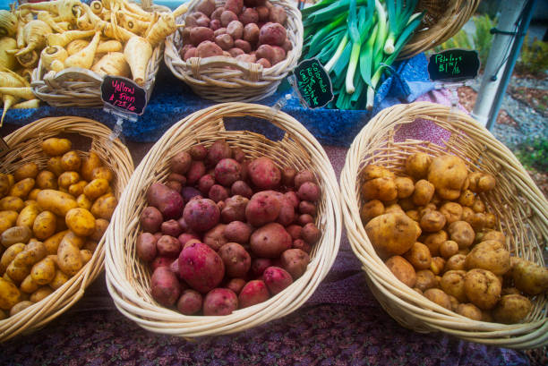 baskets of parsnips, potatoes and leeks at the farmer's market