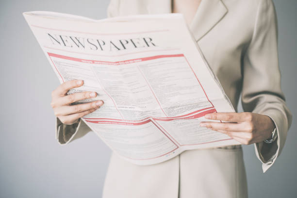 istock Young woman reading the newspaper 948025234