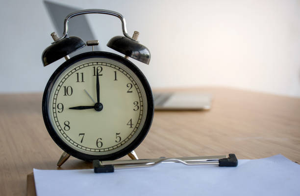 istock Vintage alarm clock on wood table with blurred abstract background 948030894