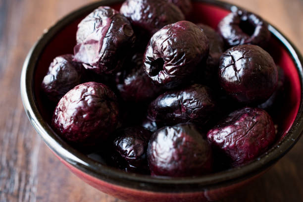 istock Dried Black Olive Chips / Crackers without seeds in Bowl. 948031636