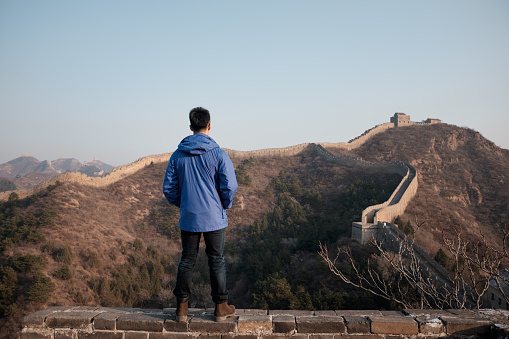 A man is looking at Great Wall of China