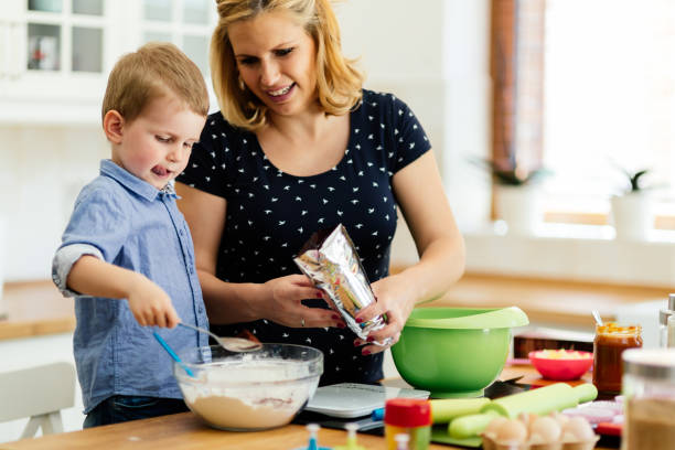 istock Mother and child preparing cookies 948042688