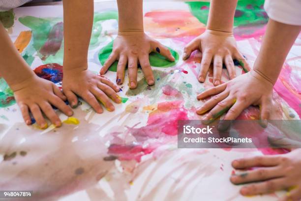 Close Up Colored Kids Hands On The Table Stock Photo - Download Image Now - Child, Preschool, Playing