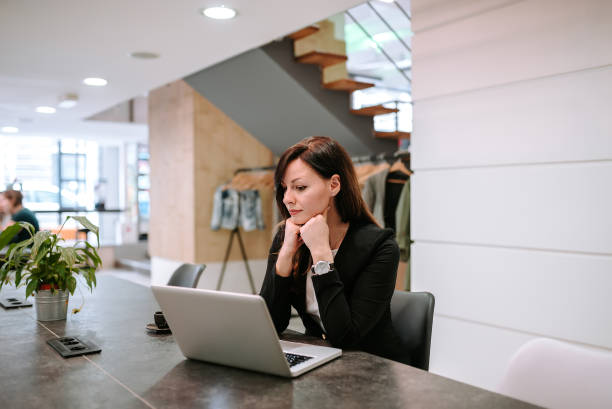 istock Charming businesswoman looking at laptop screen. 948055836