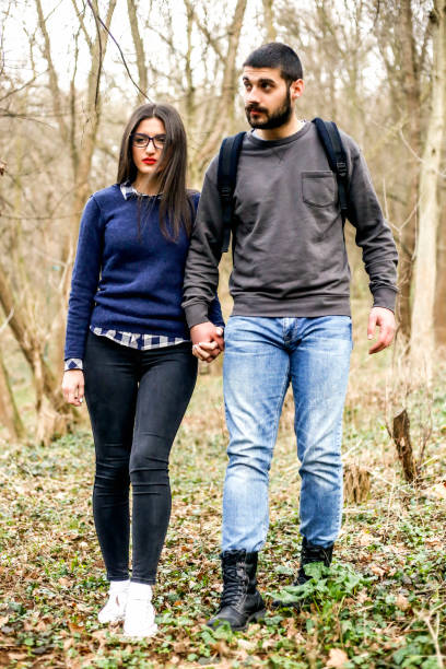 istock Young couple in love walking in forest 948056180