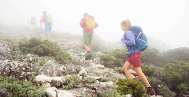 istock Men and women hiking on mountain trail 948056864