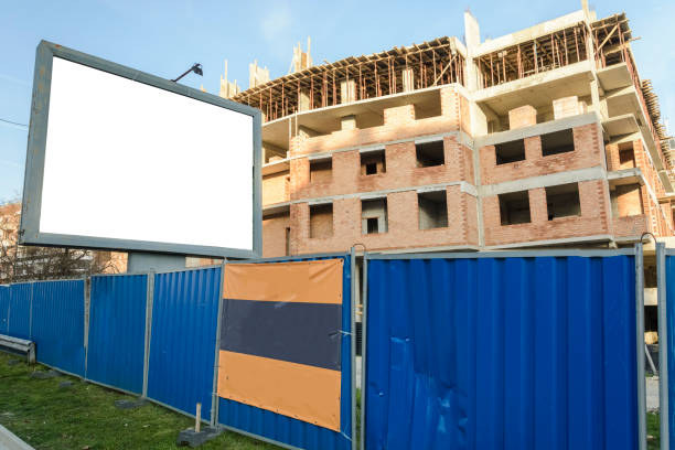 istock Blank billboard near a building in construction. 948068370