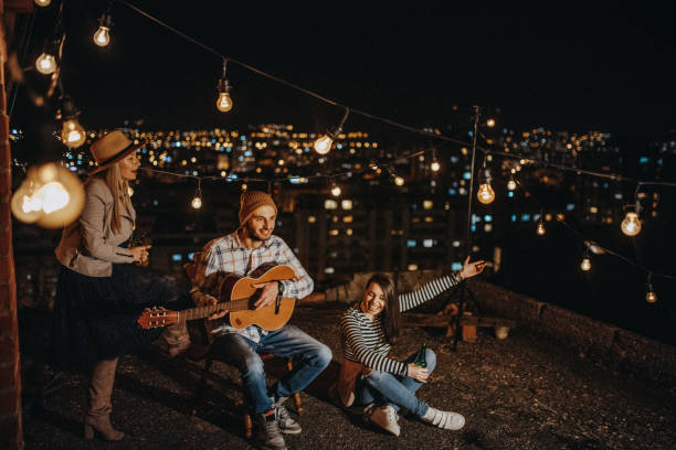 istock Friends drinking and partying on the rooftop 948069450