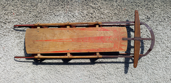 Vintage wood sled with metal runners.