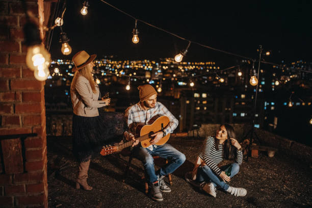 istock Friends drinking and partying on the rooftop 948070152