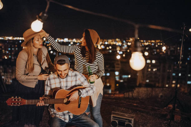 istock Friends drinking and partying on the rooftop 948075414