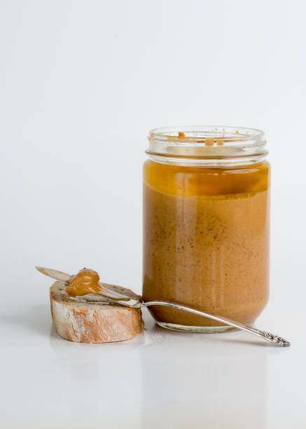 istock Old fashioned natural peanut butter in glass jar 948075636