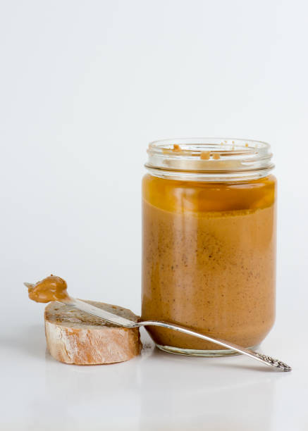 istock Old fashioned natural peanut butter in glass jar 948075886