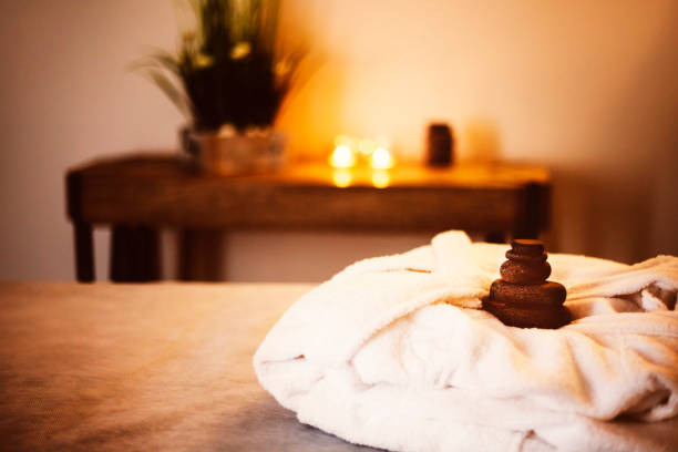 istock White bathrobe on the bed in the spa salon 948081756