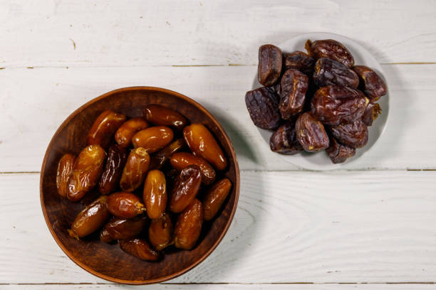 istock Dried dates fruit on white wooden table. Top view 948081932