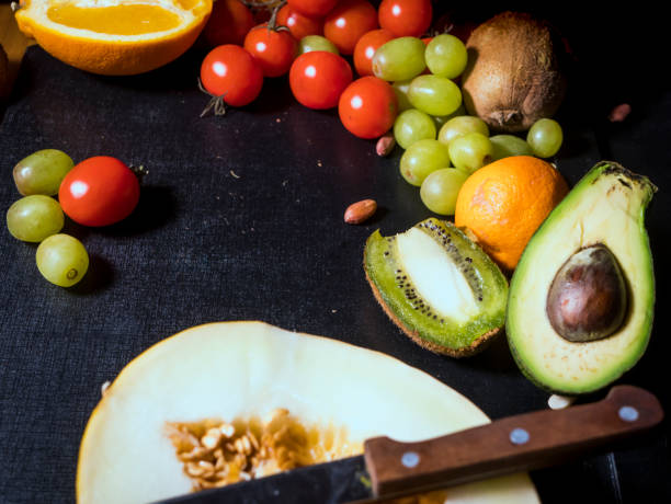 istock close up sliced tropical fresh raw fruits on dark surface 948082078