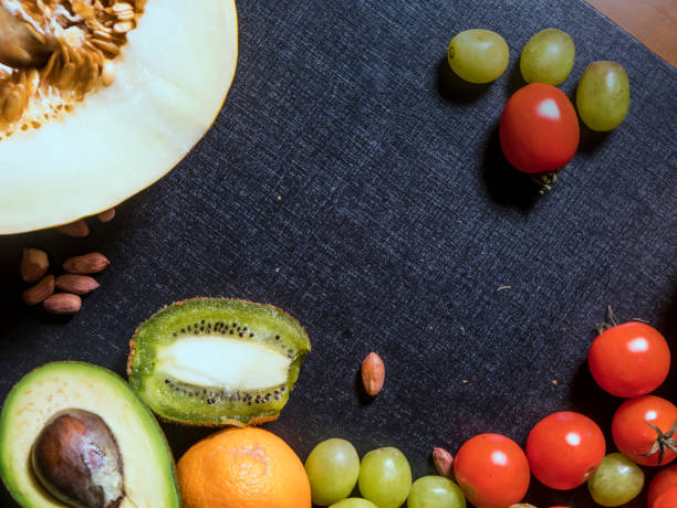 istock fresh tropical fruits on dark black surface copy space 948082108