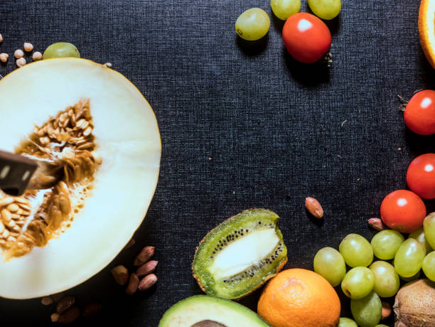 istock sliced fresh summer tropical fruits on the dark surface 948082132