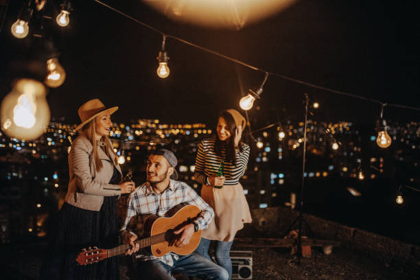 istock Group of young friends dancing at rooftop party 948082174