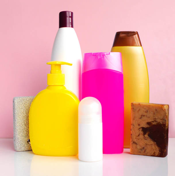 istock Body care products on white table over pink background, copy space 948089786