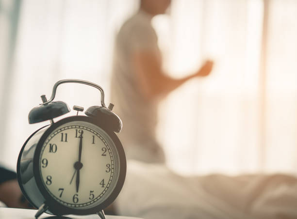 istock Man woke up early the clock showing 6 o clock 948094030