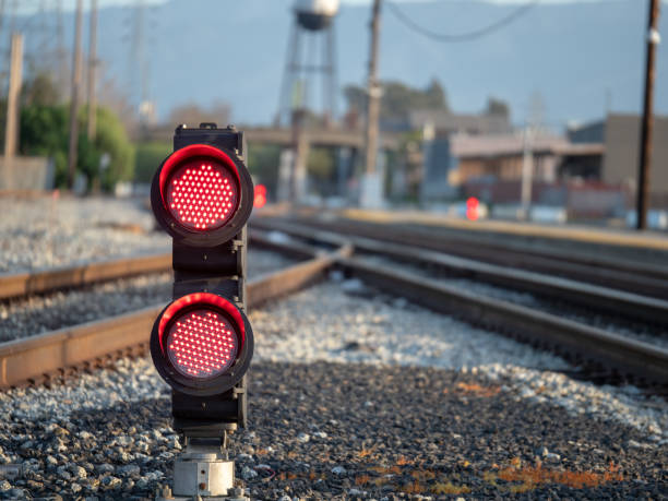 istock Red flashing lights on ground level at the railroad 948094520