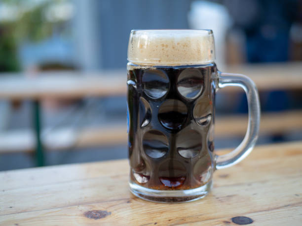 istock Full, frosty German beer mug sitting on table, space to left 948094586