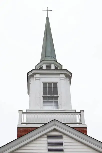 Old church steeple shot against white background.