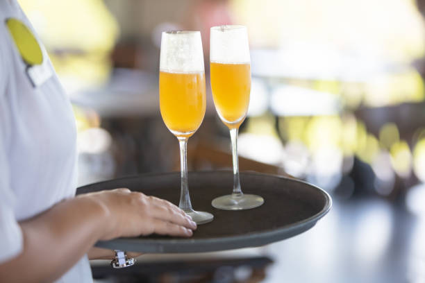 Wait staff serving mimosa cocktail