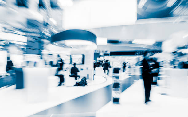 blurred people at a trade fair hall