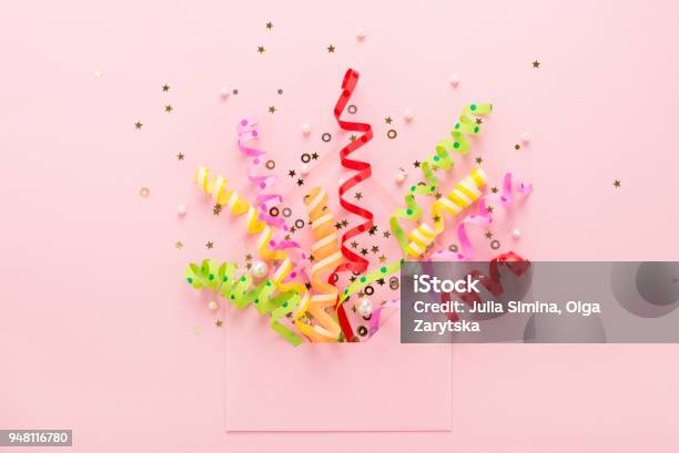 Party Confetti Sequins Explosion From Envelope On Pink Stock Photo - Download Image Now